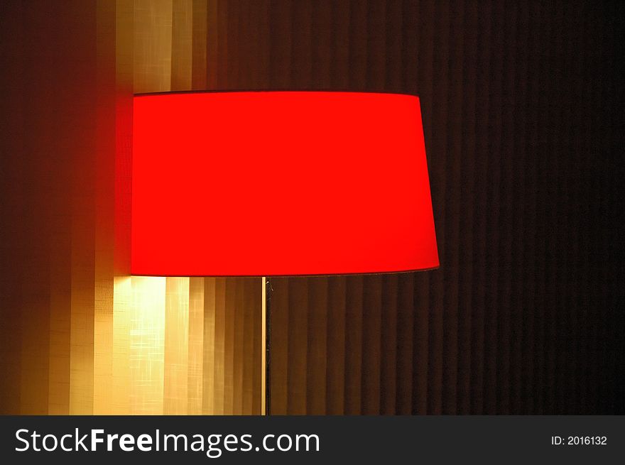 Red lamp in interior by the window. Indoor illumination.