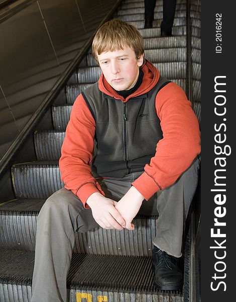 Man at Moscow subway. Sittting on steps of escalator. Man at Moscow subway. Sittting on steps of escalator