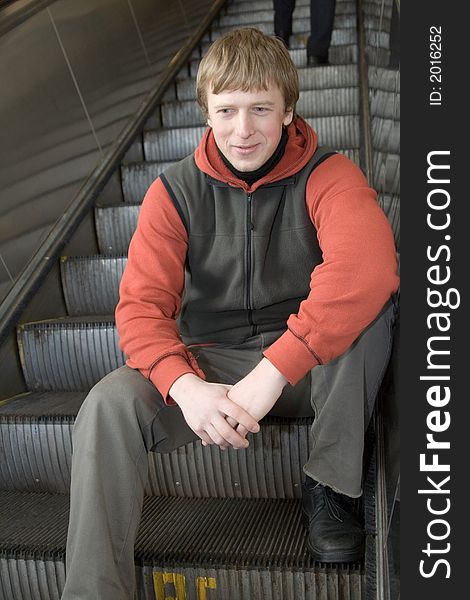 Man at Moscow subway. Sittting on steps of escalator. Man at Moscow subway. Sittting on steps of escalator