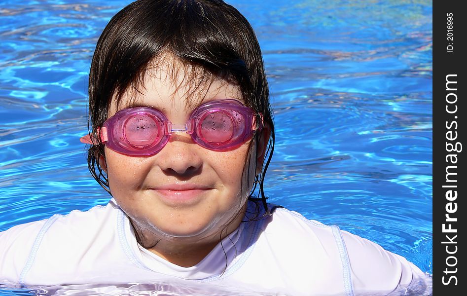 A young girl smiling and enjoying her swim. A young girl smiling and enjoying her swim