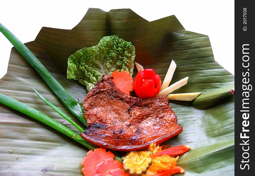 Delicious pork chop served on a banana leaf. Delicious pork chop served on a banana leaf