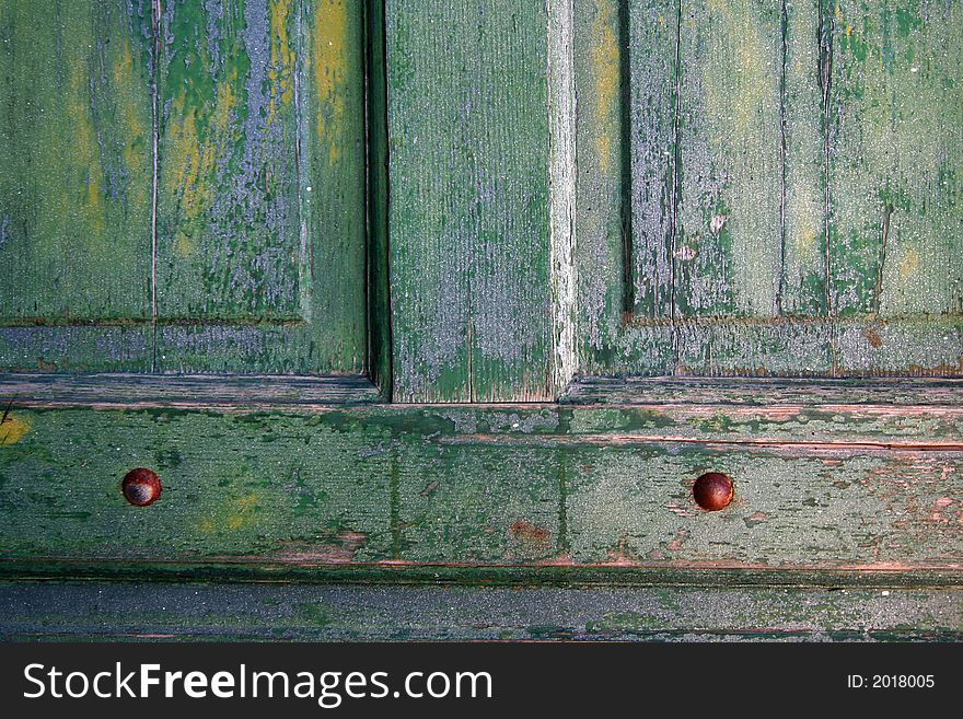 A green weathered door from a Coast Guard lifeboat station