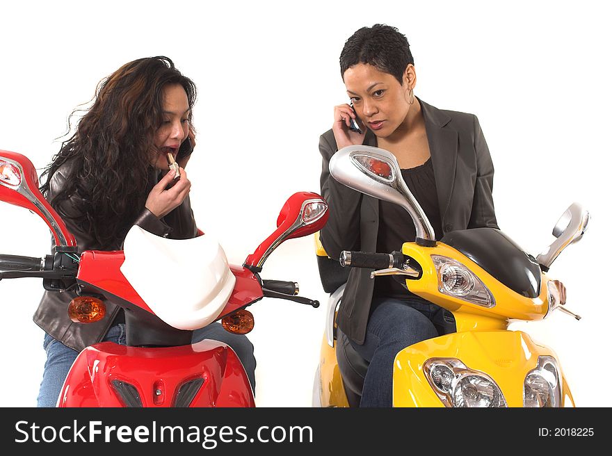 Couple girls talking on cell phone and doing make up over white background