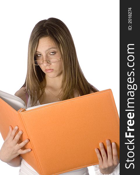 Teenager looking up from orange book rolling her eyes through glasses. Teenager looking up from orange book rolling her eyes through glasses