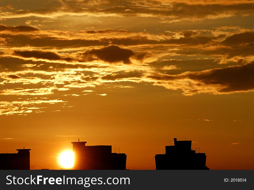 Sunset and golden skies in the city silhouette. Sunset and golden skies in the city silhouette