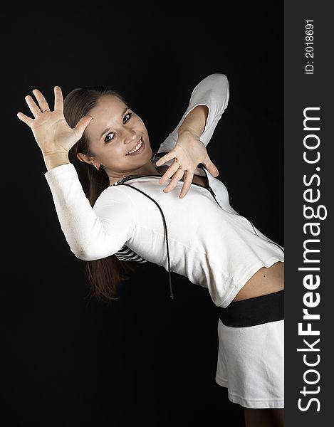 Smiling girl with raised hands in sportive wear on black background. Smiling girl with raised hands in sportive wear on black background