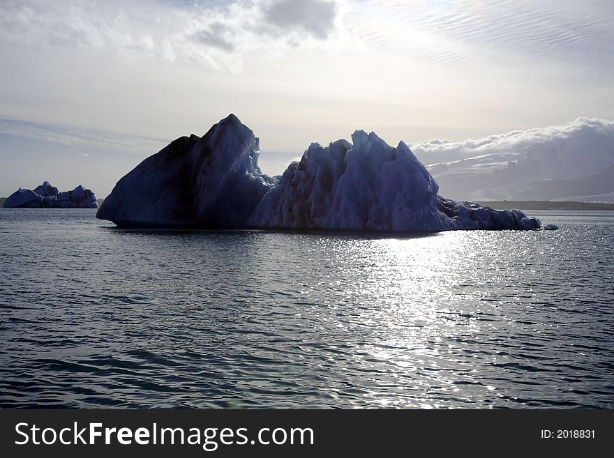 Silhouetted icebergs floating on Jokulsalon lagoon