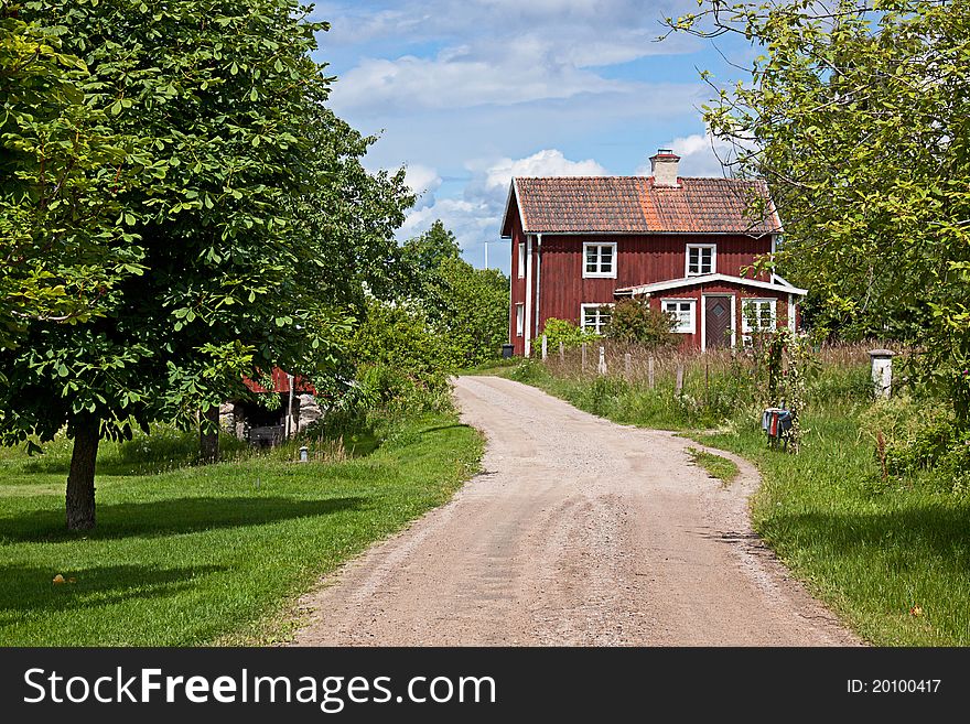 Red cottage and way through the old village. Red cottage and way through the old village.