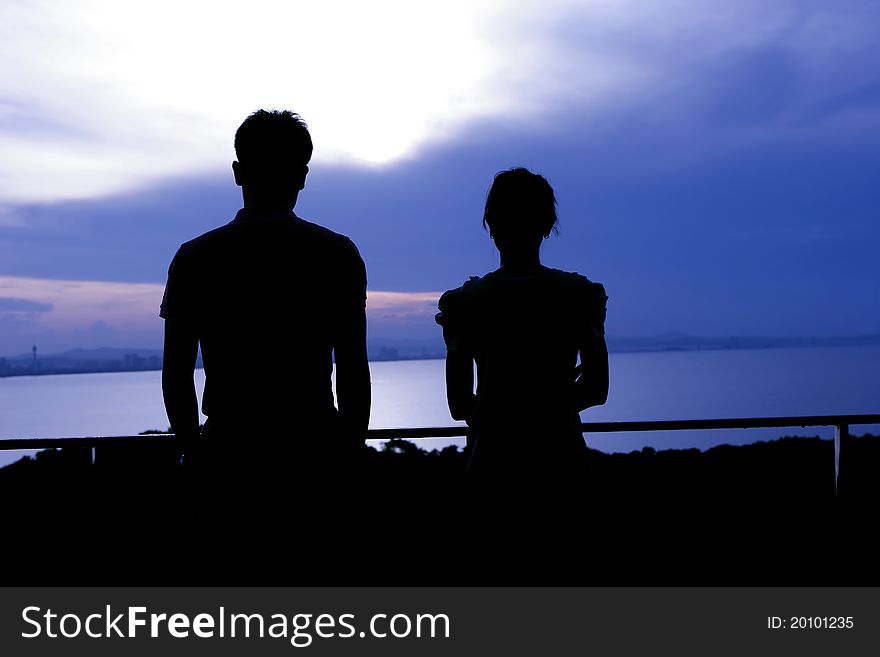 Couple on a vantage point at dawn. Couple on a vantage point at dawn.