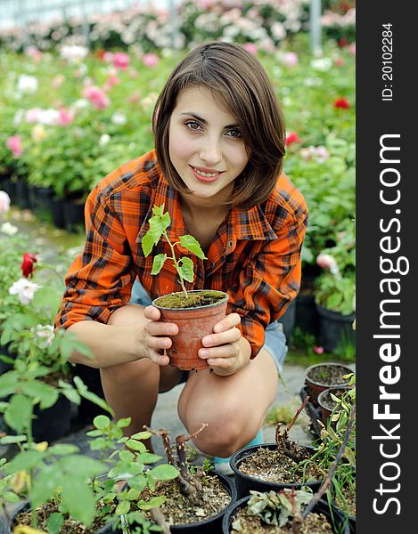 An image of a girl with a plant in a pot