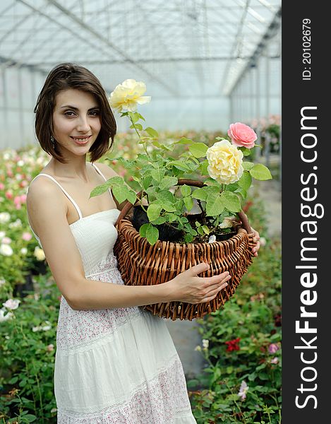 An image of a nice young girl in a greenhouse. An image of a nice young girl in a greenhouse