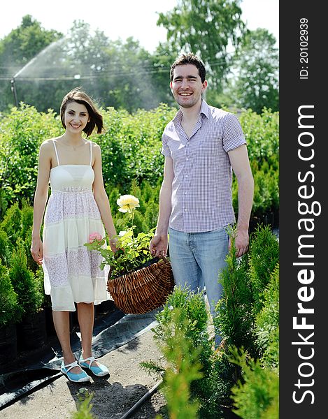An image of a young couple with basket with roses. An image of a young couple with basket with roses