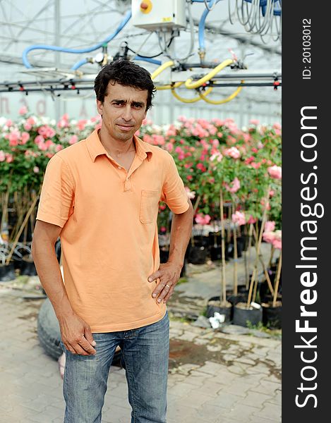 An image of a young gardener in a greenhouse