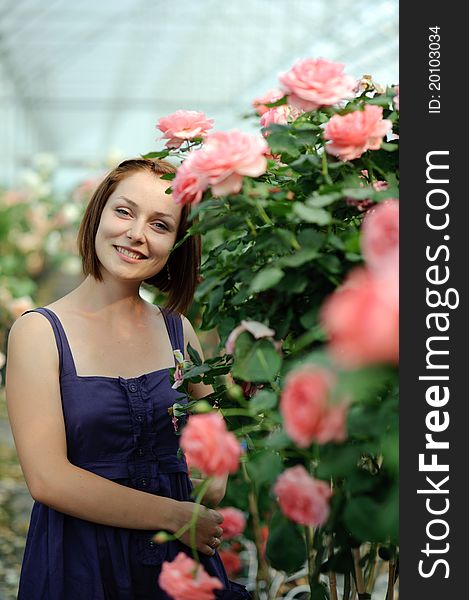 An image of a young woman in the greenhouse. An image of a young woman in the greenhouse