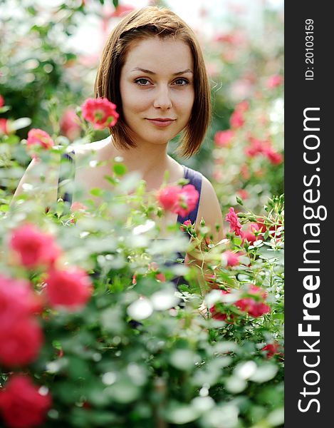 An image of a young beautiful woman and roses