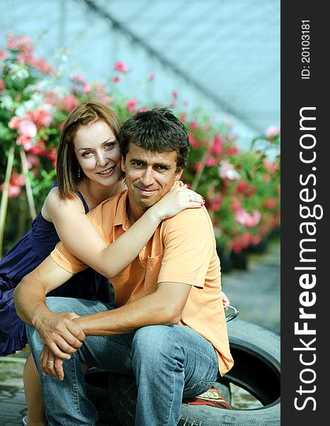 An image of a young couple in a greenhouse