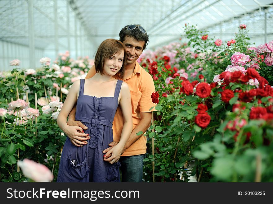 An image of a woman and a man in greenhouse. An image of a woman and a man in greenhouse