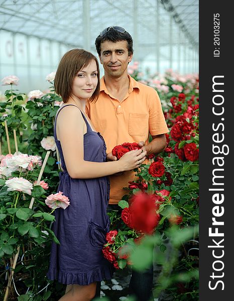 An image of a woman and a man in a greenhouse