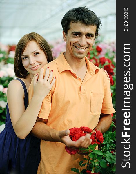 An image of a young couple in a greenhouse. An image of a young couple in a greenhouse