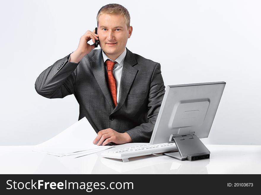 Young successful business man with a telephone and computer