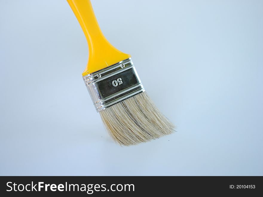 Yellow paint brush works without color isolated on background