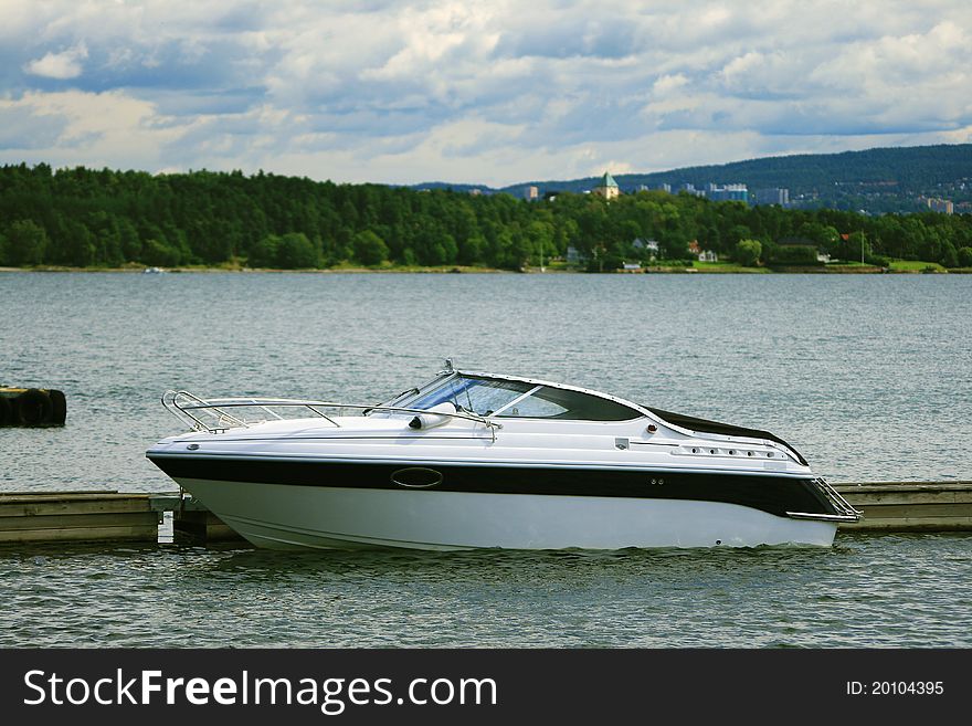 Modern motorboat staying in dock. Modern motorboat staying in dock