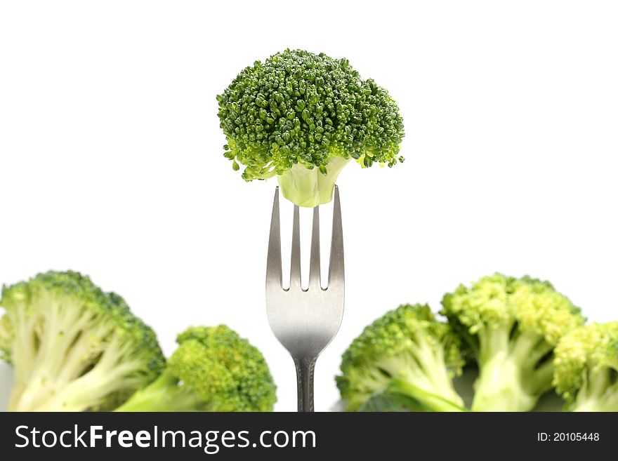 Fresh broccoli on fork ,white background.