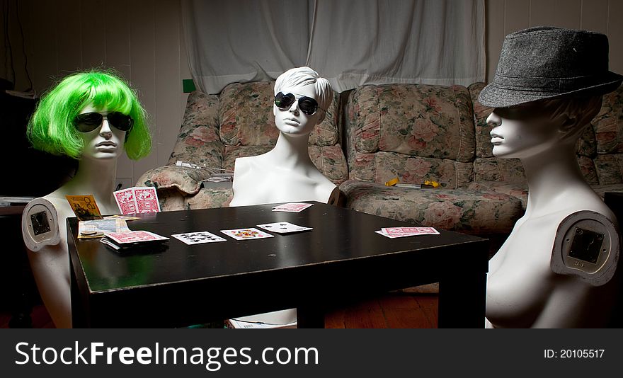 Three mannequins playing poker in the house. Three mannequins playing poker in the house.