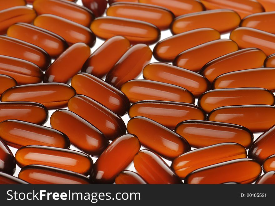 Closeup bright orange capsules background. Closeup bright orange capsules background