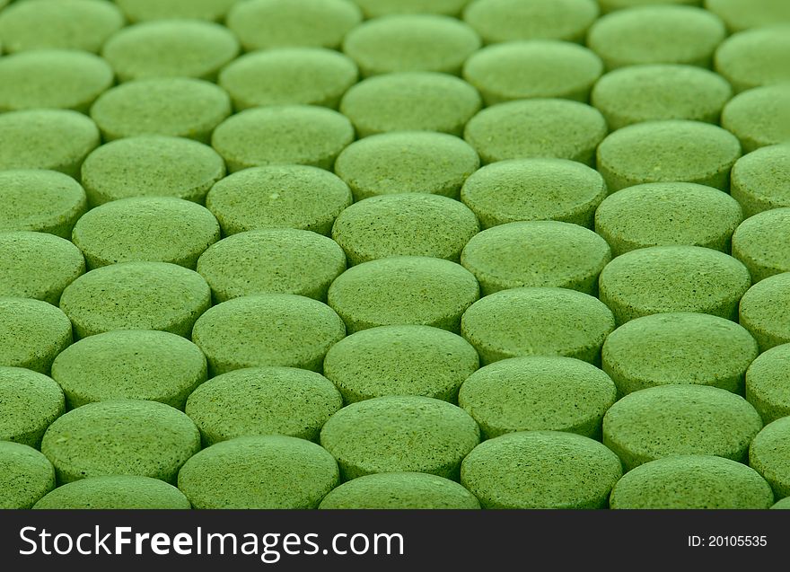 Closeup background of green pills