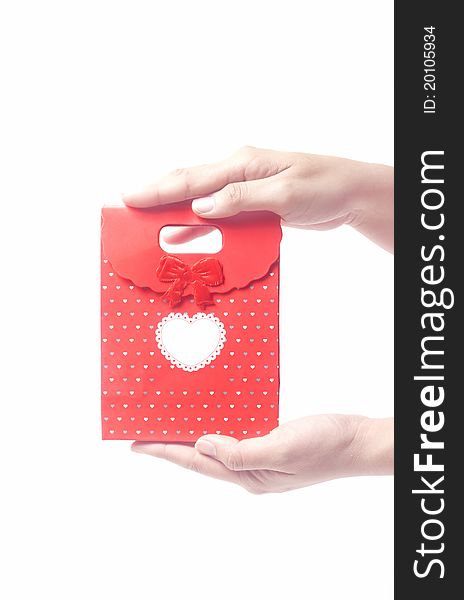 Hand holding red gift bag, isolated on the white background