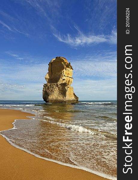 A view off the south coast of Australia with a cloudy sky with a large rock coming out of the sea. A view off the south coast of Australia with a cloudy sky with a large rock coming out of the sea.