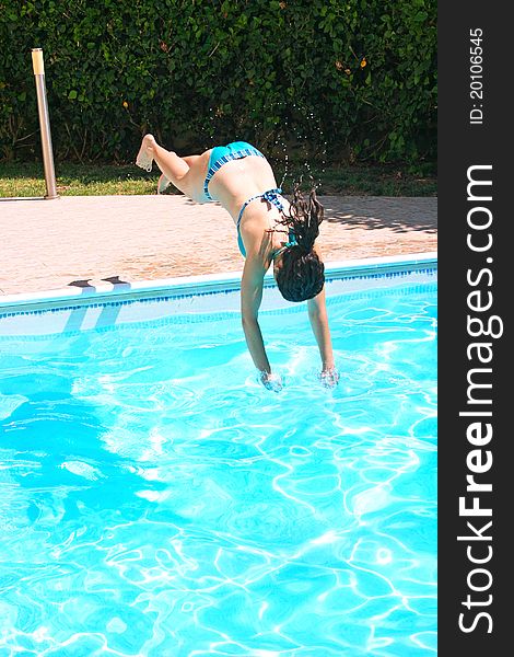 Woman jumping to swimming pool