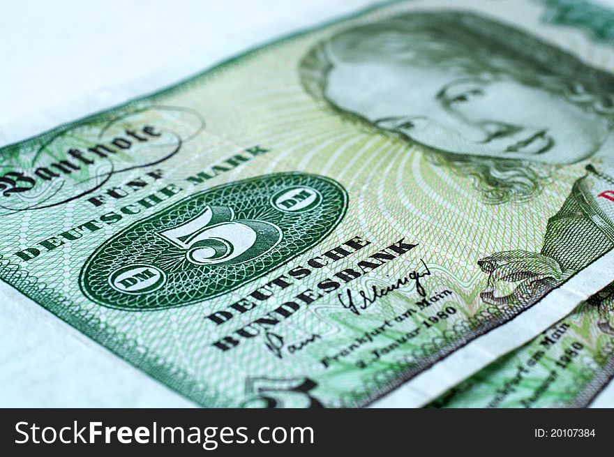 Currencies with a Five German Mark Banknote, Macro Photograph with Blur effect