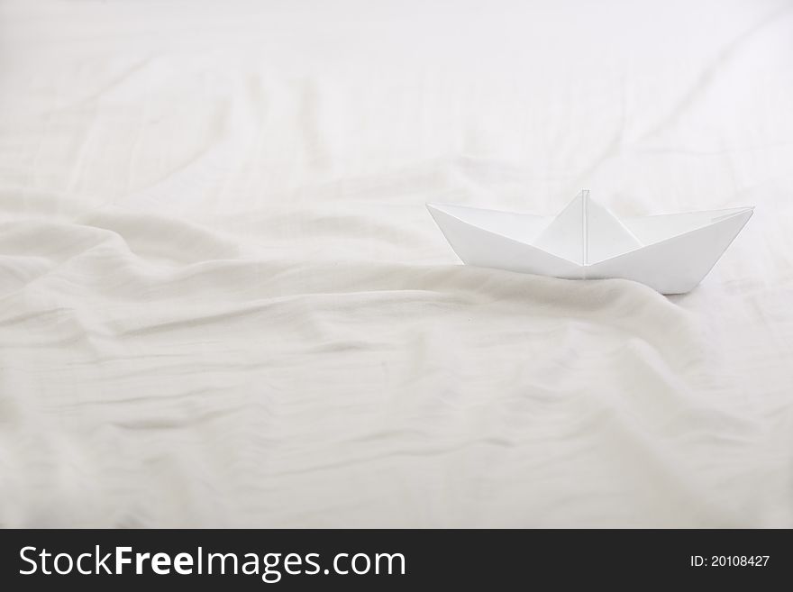 Paper Boat in the bed Sheet Sea