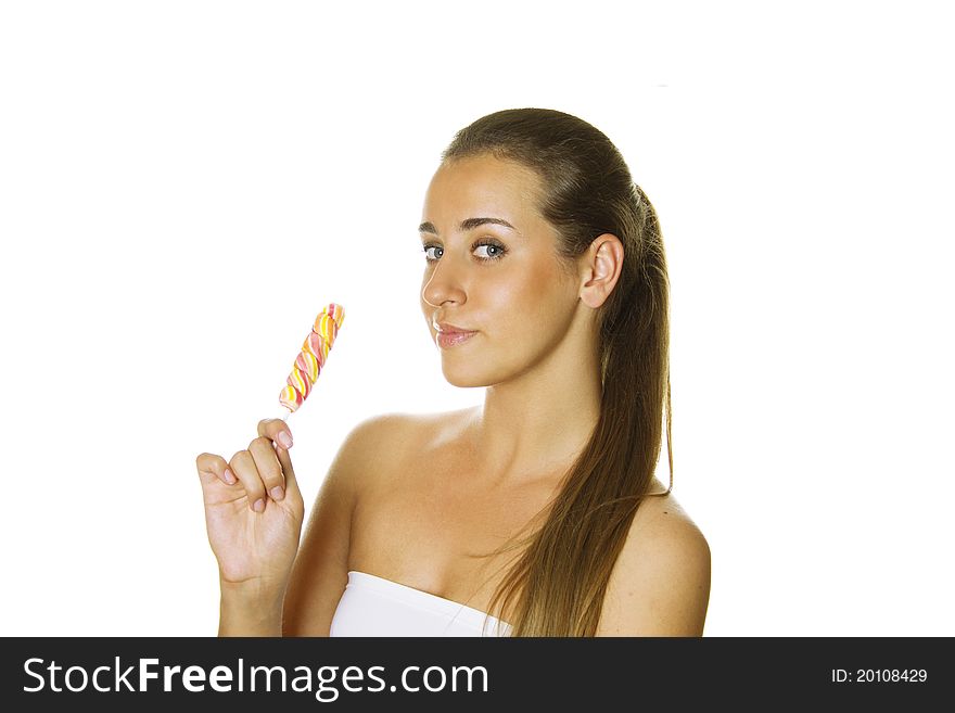 Close-up of an attractive young woman with a bright candy. Isolated on a white background. Close-up of an attractive young woman with a bright candy. Isolated on a white background