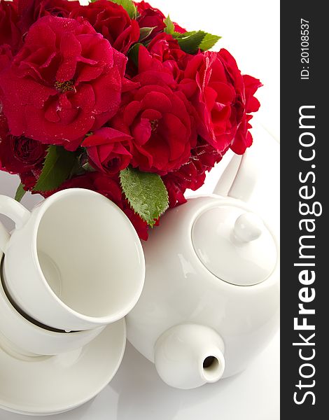 White Crockery For Tea And A Bouquet Of Roses