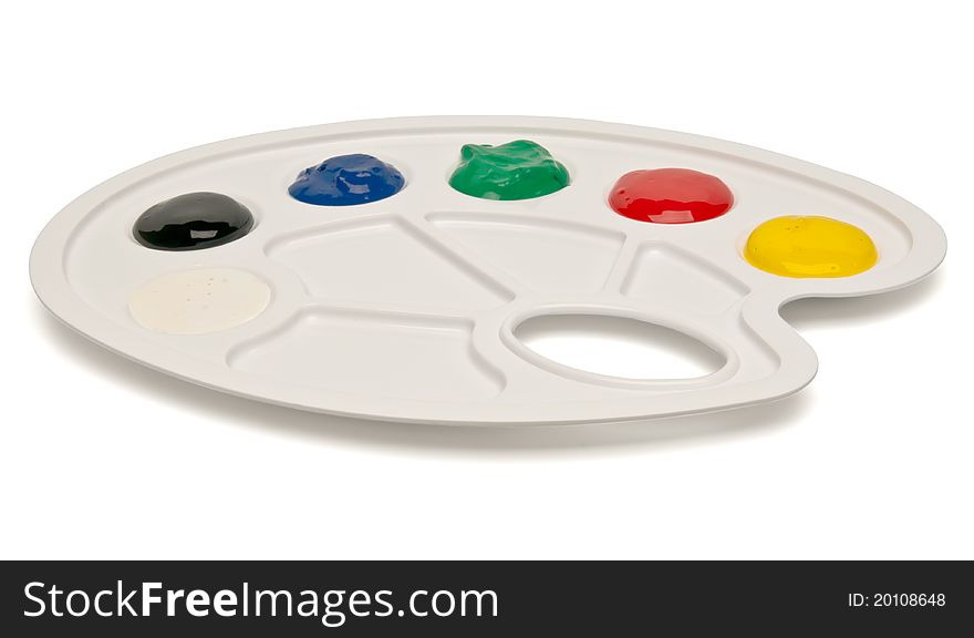 Plastic palette with paints isolated on white background