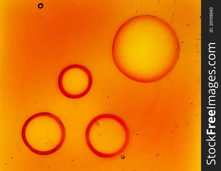 Orange glass background with four big bubbles