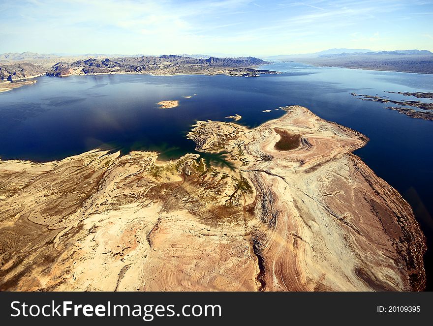 Helicopterview in blue bright sky over the rocky mountains landscape