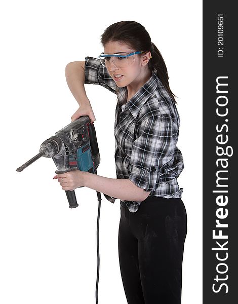 Young girl in a glasses hold a perforator. Young girl in a glasses hold a perforator