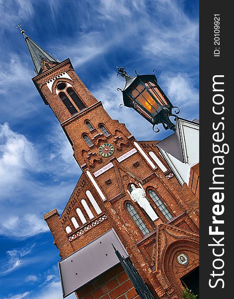 Red church against blue sky.Belarus.