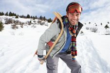 Young Man Carrying Sled In Alpine Landscape Royalty Free Stock Photography