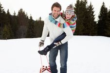 Young Father And Daughter In Snow With Sled Royalty Free Stock Images