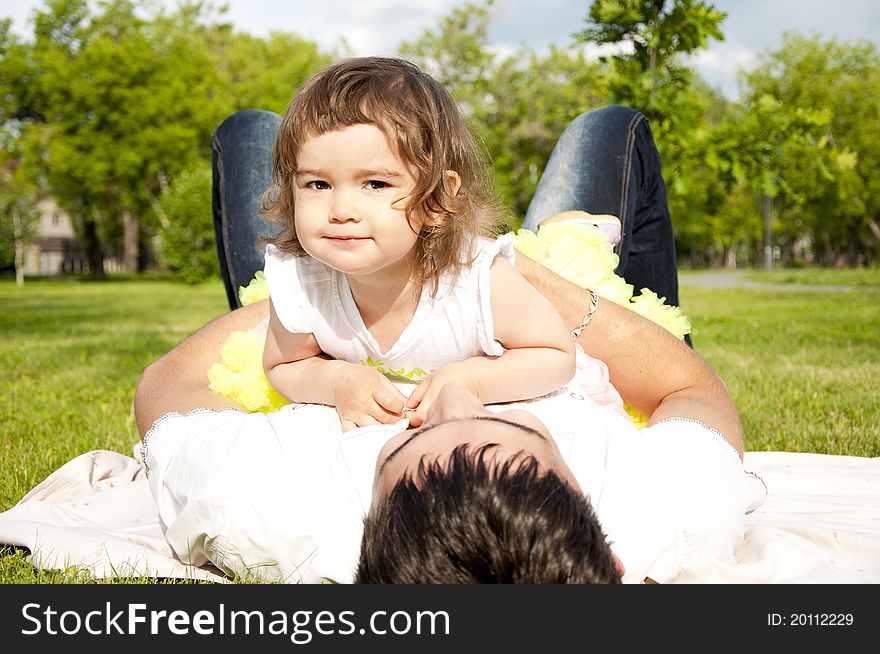 Father Holds The Cheerful Daughter In His Arms