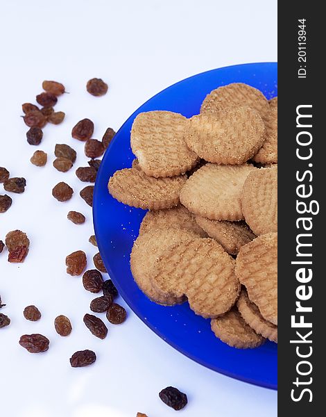 Delicious biscuits with raisin on blue plate