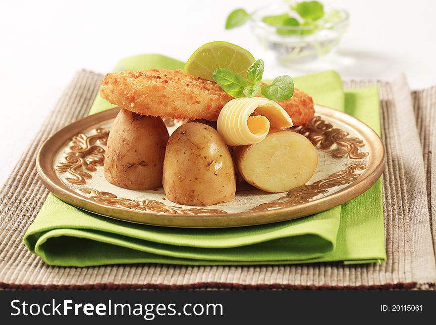 Fried fish fillet served with new potatoes. Fried fish fillet served with new potatoes