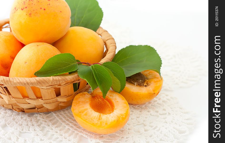 Apricots in a basket over white