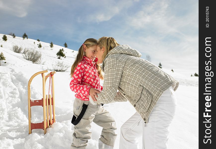 Young Mother And Daughter On Winter Vacation having fun