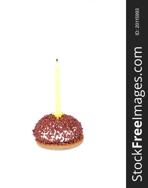 Cake  with single yellow candle emphasising simplicity on isolated background